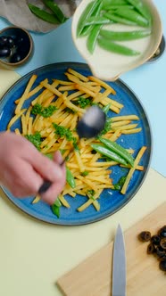 Vertical Tabletop Video Chef Adds Sweet Pea Pods to the Fried Potato Dish