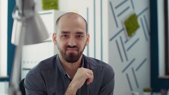 Portrait of Office Worker Sitting at Desk to Create Business Report