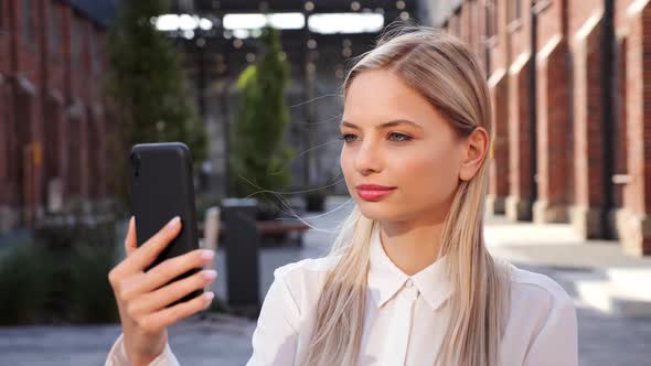 Joyful Beautiful Female Recording Vlog in Street