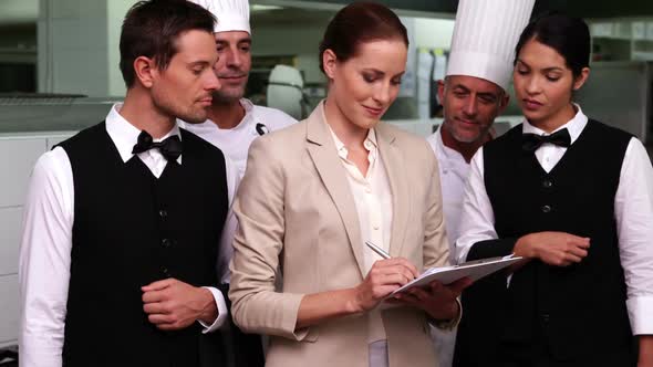 Happy restaurant staff with manager smiling at camera