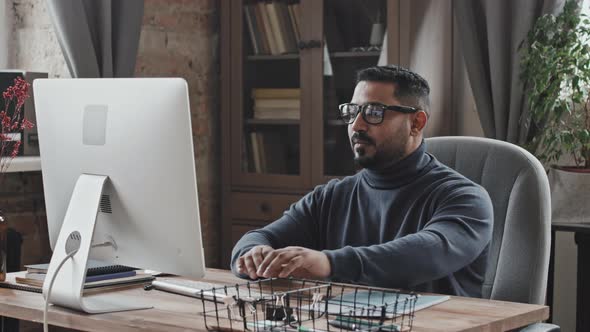 Portrait of Businessman Working on Computer in Home Office