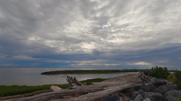 Time-lapse on the shores of Garry Point Viewpoint on a cloudy day with a fishing boat passing by