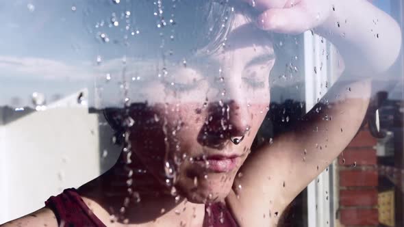 Thoughtful woman drinking coffee near window