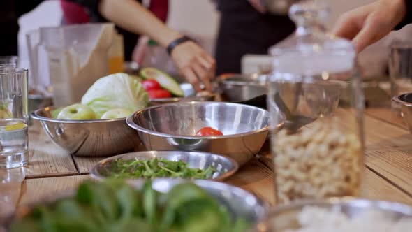 Close Up Footage of Table with Dishes with Vegetables Greenery Bread and Other Food in Slowmotion