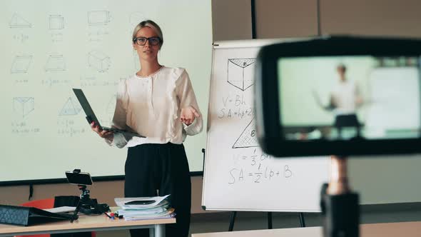 A Woman is Conducting a Geometry Lesson While Being Filmed Online