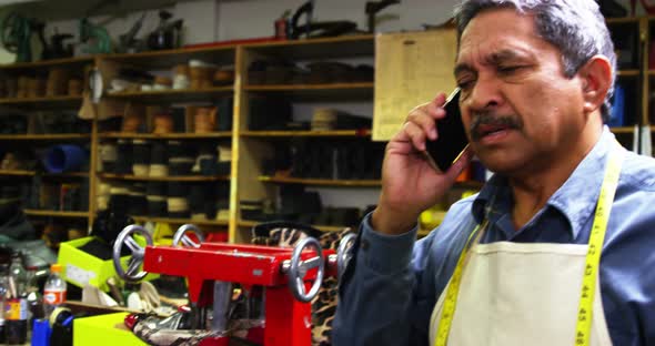 Shoemaker talking on the mobile phone