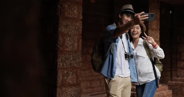 Couple selfie on smartphone in ancient temple