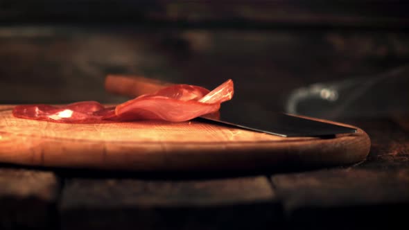 Super Slow Motion Fragrant Pieces of Dried Meat Fall on the Cutting Board