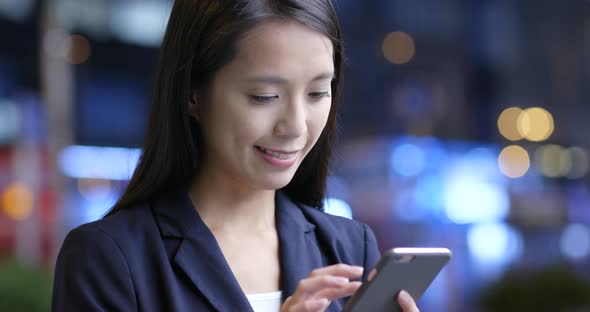 Businesswoman Use of Smart Phone in Hong Kong City at Night