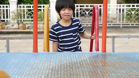 Asian Child Playing On Playground In Summer Outdoor Park Slow Motion