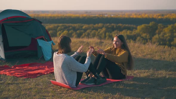 Girls Tourists Do Abs Exercises on Mat at Campsite