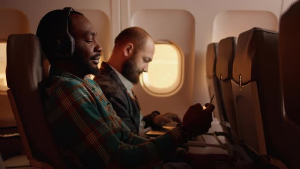 Male Passenger Talking to Flight Attendant on Airplane