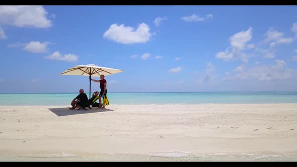 Boy and girl tanning on marine coastline beach adventure by blue sea with white sand background of t