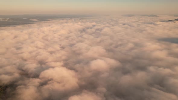 4K Aerial video Beautiful sunrise above dense clouds and fog in the morning, Cinematic drone shot.