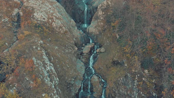 Waterfall Cascade in Tropical Rainforest with Rock