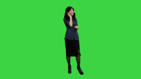 Beautiful Chinese Ssian Woman Talking on Mobile Phone on a Green Screen, Chroma Key