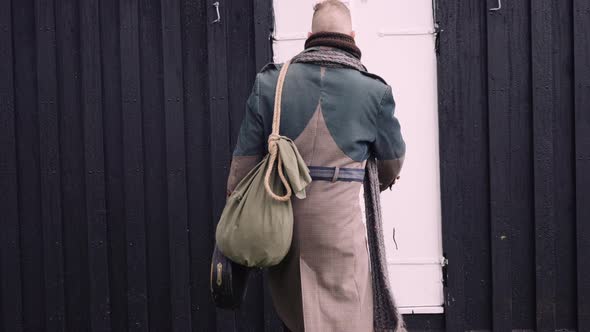 Stylish Man with  a Sack Bag and a Banjo Case Gets In the Little Black House
