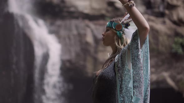 Woman with Sexy Body is Posing Near Waterfall