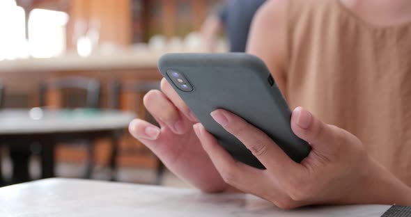 Woman use of mobile phone in restaurant