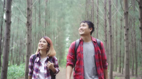 Hiker Asia backpacker couple adventure feeling freedom walking in forest, enjoy their holidays.