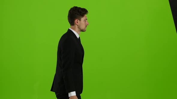 Man Is Going To a Business Meeting and Waving Greetings. Green Screen. Side View