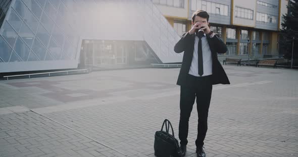 Charismatic Business Man in a Suit Taking a Coffee