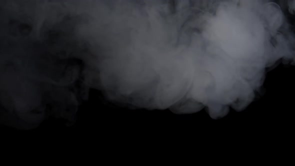 White Smoke Explosion And Spins Around Over Black Background