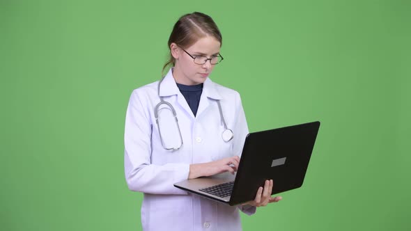 Young Happy Woman Doctor Using Laptop