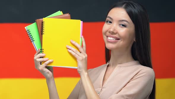 Happy Student Showing Notebooks German Flag Background, Teaching at University