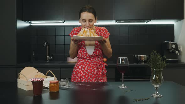 Happy smiling woman with cooked homemade pie in professional kitchen, Food and lifestyle concept