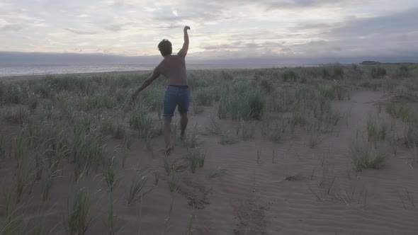 Dancing on the beach in the grass