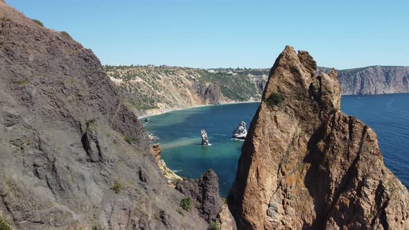 Aerial View From Above on Calm Azure Sea and Volcanic Rocky Shores