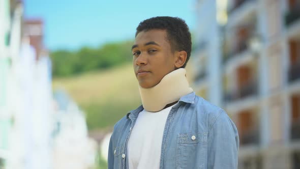 Upset Afro-American Teen Boy in Foam Cervical Collar Sadly Sighing on Cam Trauma