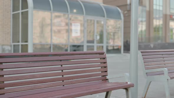 Young Man Coming and Sitting on Bench Outdoor