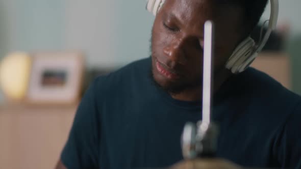African American Guy Playing Drums with Closed Eyes