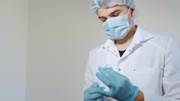 A Medical Student Opens an Ampoule and Draws an Injection Into a Syringe.