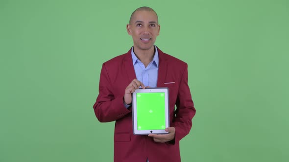 Happy Bald Multi Ethnic Businessman Presenting with Digital Tablet