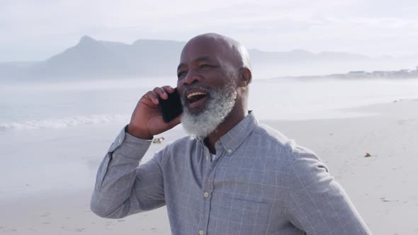 Mature man enjoying time outside by the sea