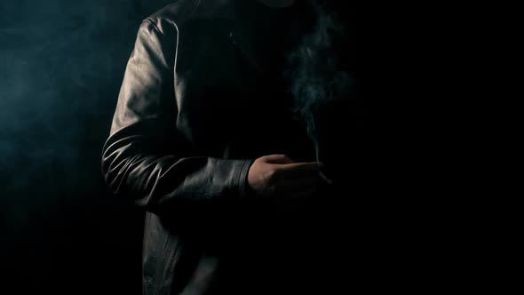 Anonymous Man Smoking In The Dark