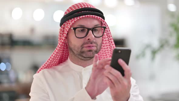 Young Arab Businessman Using Smartphone