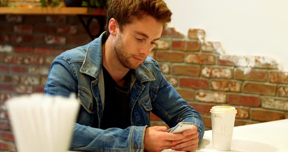 Man using mobile phone at table