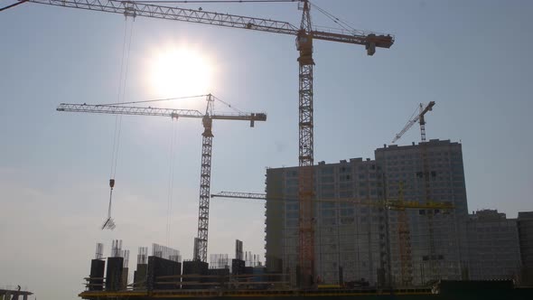 Yellow Crane Carrying a Metal Frame on the Construction