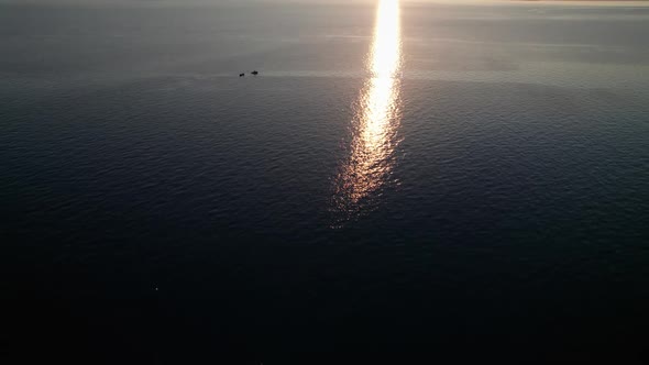 Aerial View of Landscape Sunset Over the Sea Leaves Trail and Glare on the Water