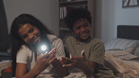 Siblings Playing with Flashlight