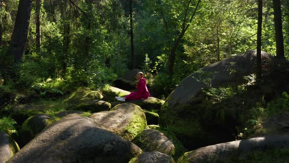 A Girl Practices Yoga in the Forest