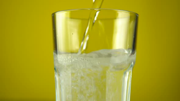 Pouring Water with Gas in Drinking Glass