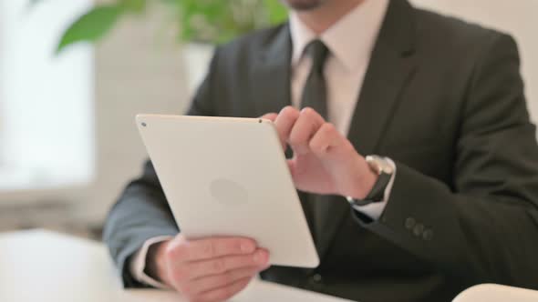 Close Up of Hands of Middle Aged Businessman Reacting to Failure on Tablet