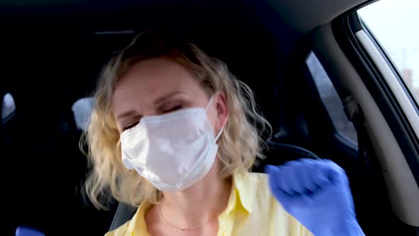 Curly Blonde Girl Driver in Medical Mask and Protective Gloves Dancing in Car Before Driving