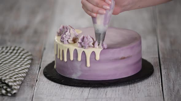 Chef Decorating Cake with a cream.	