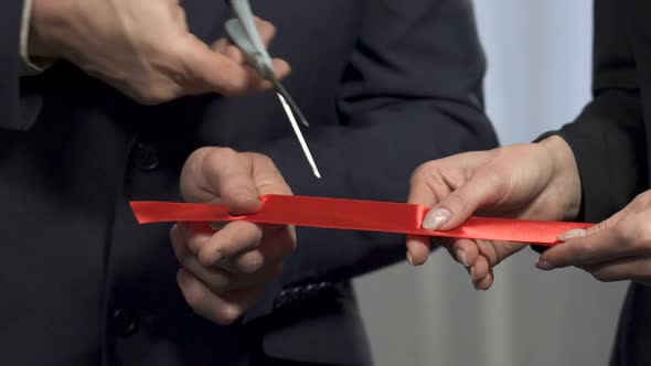 Business Partners Cutting Red Ribbon and Shaking Hands, Partnership, Agreement